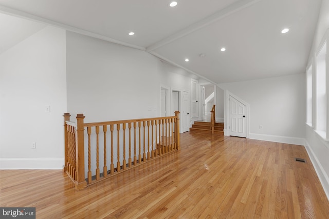 bonus room featuring lofted ceiling and light hardwood / wood-style floors