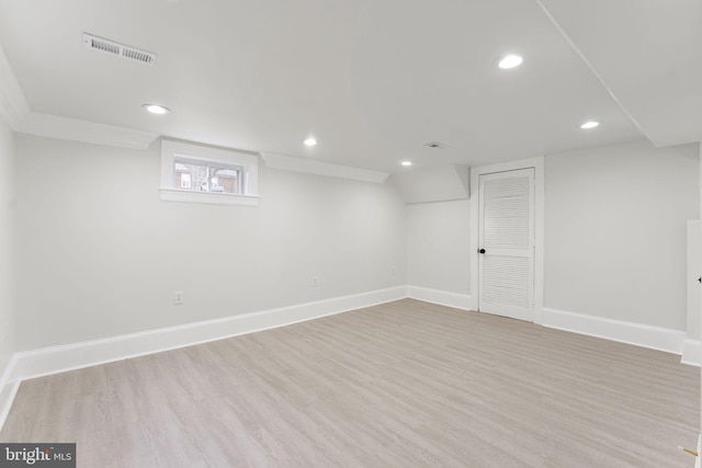 basement with light hardwood / wood-style flooring