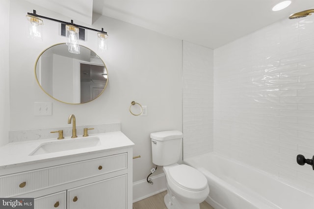 full bathroom featuring vanity, tiled shower / bath, and toilet