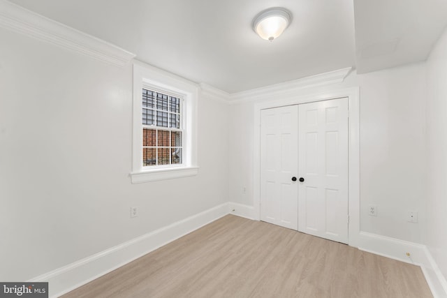 unfurnished bedroom featuring a closet and light hardwood / wood-style flooring