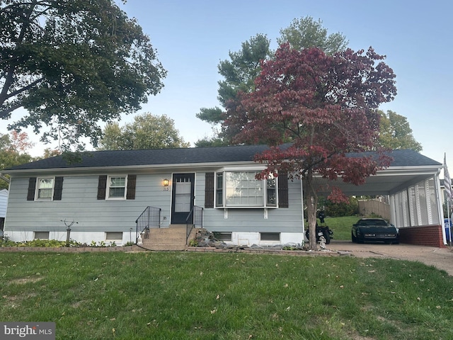 view of front facade with a carport and a front lawn