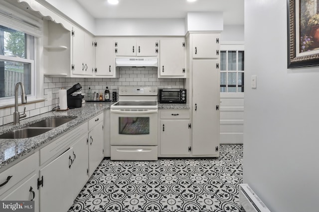 kitchen with electric range, sink, white cabinets, and light stone counters