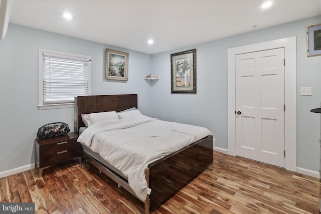 bedroom with hardwood / wood-style flooring