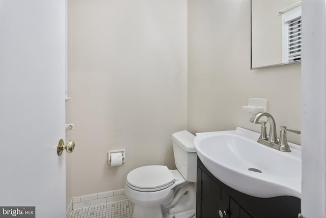 bathroom featuring tile patterned floors, vanity, and toilet