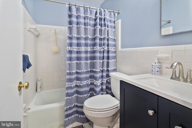 full bathroom featuring shower / tub combo, vanity, tile walls, and toilet