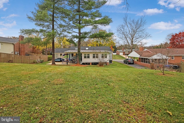 rear view of house featuring a lawn