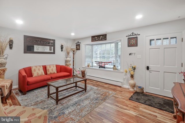 living room featuring wood-type flooring and a baseboard radiator