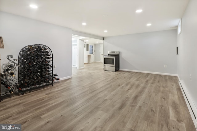 unfurnished living room featuring light hardwood / wood-style floors and baseboard heating