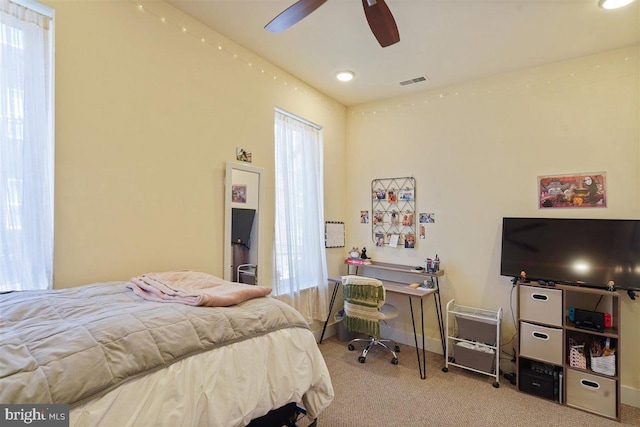 bedroom featuring light carpet and ceiling fan