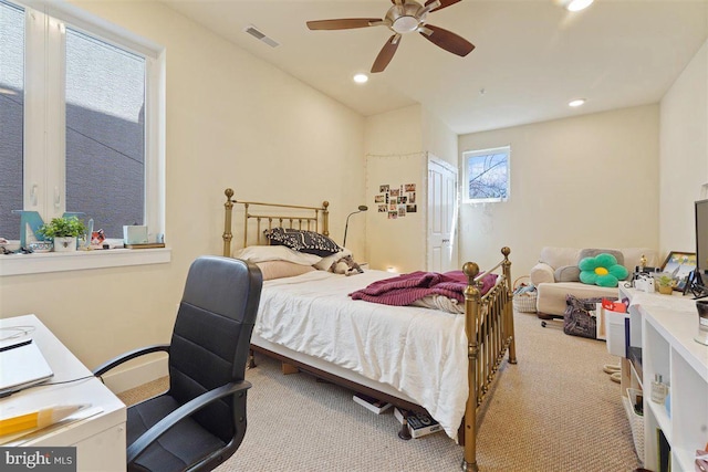 bedroom featuring light colored carpet and ceiling fan