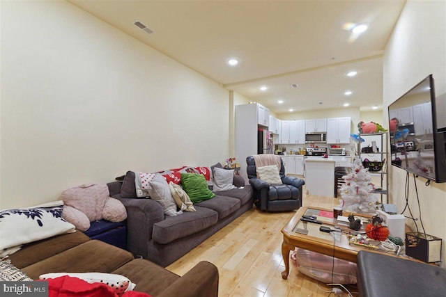 living room with light hardwood / wood-style flooring