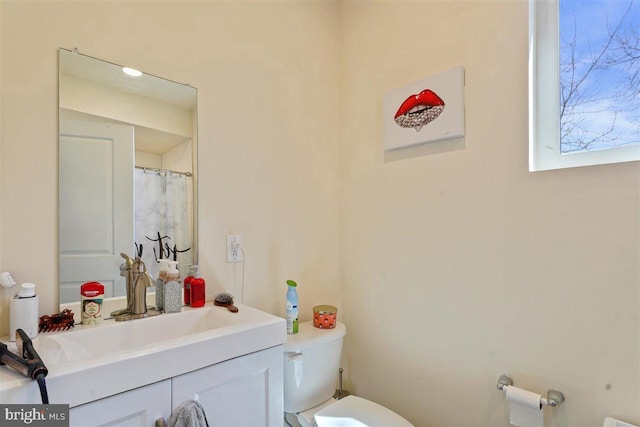 bathroom with vanity and toilet