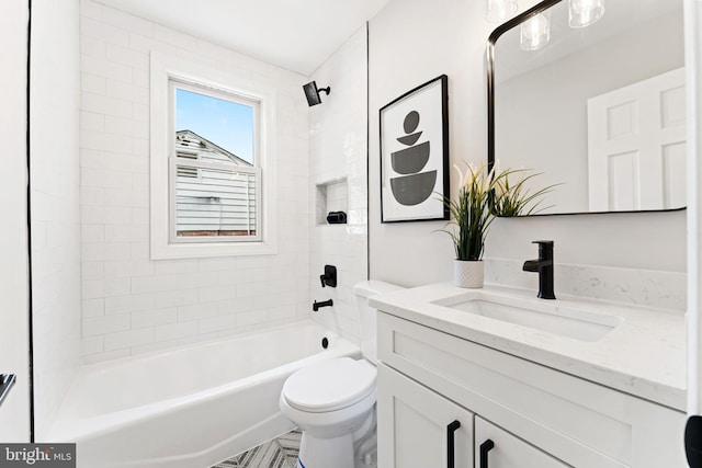 full bathroom featuring vanity, toilet, and tiled shower / bath combo