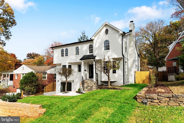 rear view of house featuring a yard