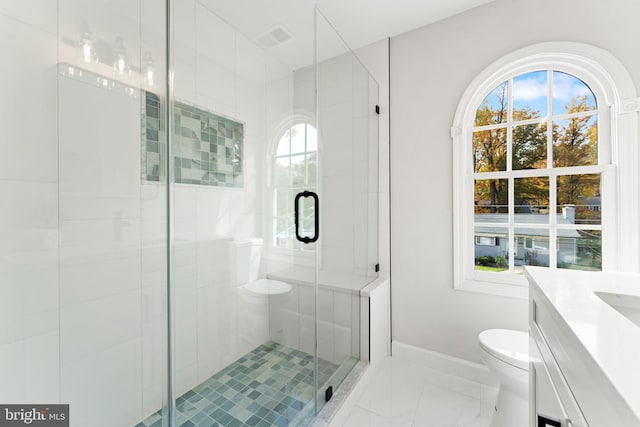 bathroom featuring vanity, walk in shower, and toilet