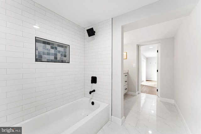 bathroom with vanity and tiled shower / bath