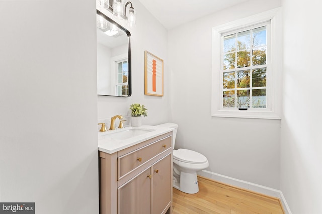 bathroom featuring vanity, toilet, and hardwood / wood-style flooring