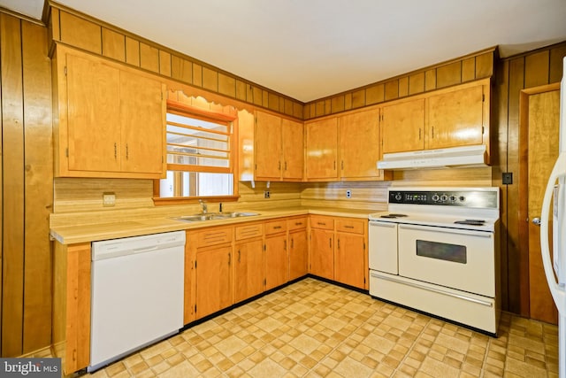 kitchen with white appliances, tasteful backsplash, and sink