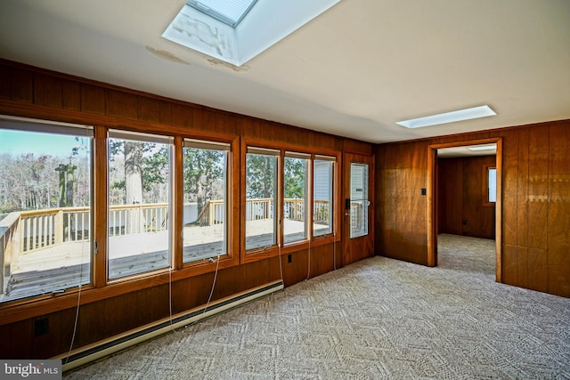 unfurnished sunroom with a skylight and a baseboard radiator