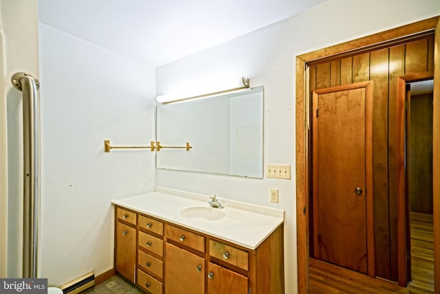 bathroom featuring vanity, hardwood / wood-style flooring, and a baseboard radiator