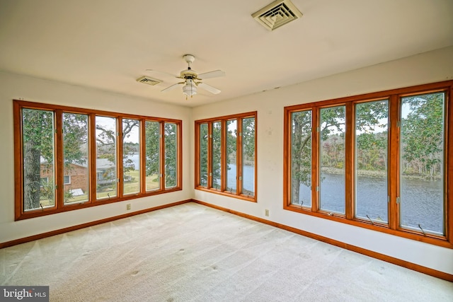 unfurnished sunroom with ceiling fan and a healthy amount of sunlight