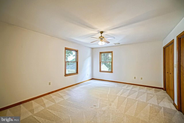 unfurnished bedroom with ceiling fan and light colored carpet