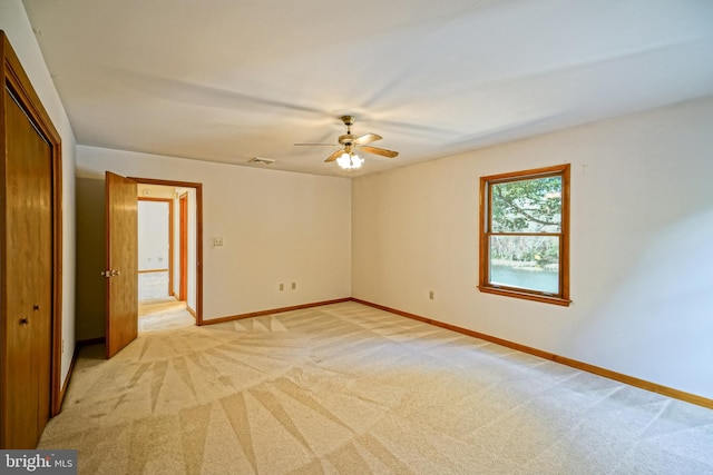 unfurnished room with ceiling fan and light colored carpet