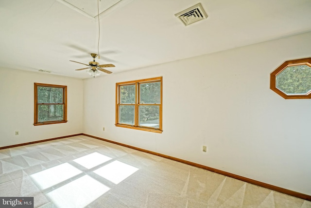 spare room with light colored carpet and ceiling fan