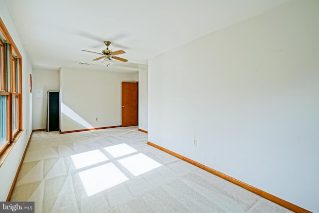 unfurnished room with light carpet and ceiling fan