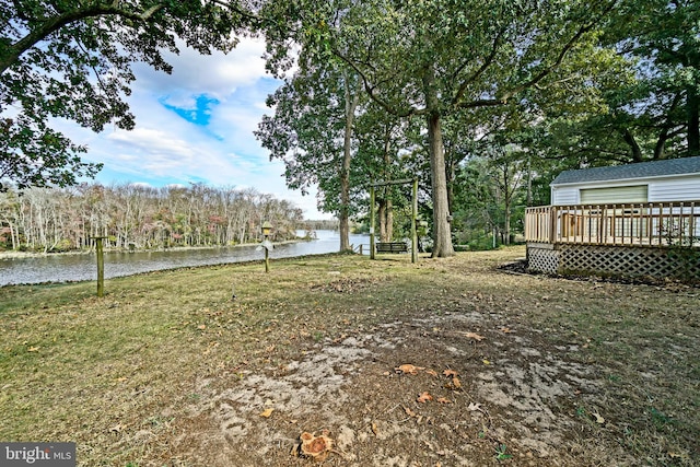 view of yard featuring a deck with water view