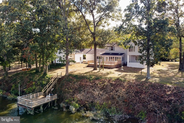 back of property featuring a deck with water view