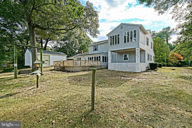 back of property with a yard and a deck