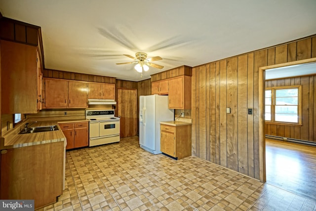 kitchen featuring a baseboard heating unit, white appliances, sink, light hardwood / wood-style floors, and ceiling fan