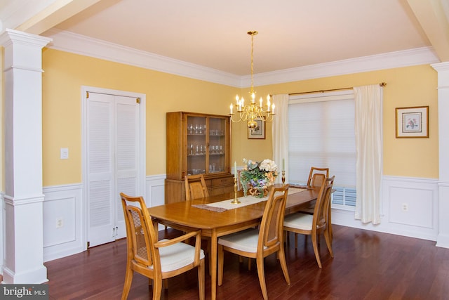 dining room with decorative columns, crown molding, an inviting chandelier, and dark hardwood / wood-style flooring