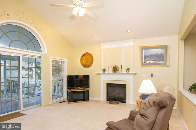 carpeted living room featuring ceiling fan and high vaulted ceiling