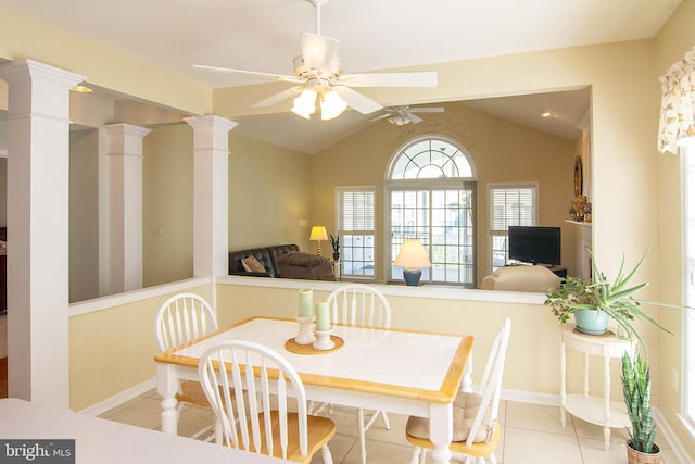 tiled dining room with ornate columns, ceiling fan, and lofted ceiling