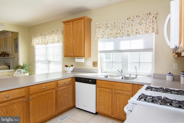 kitchen with sink, white appliances, and light tile patterned floors