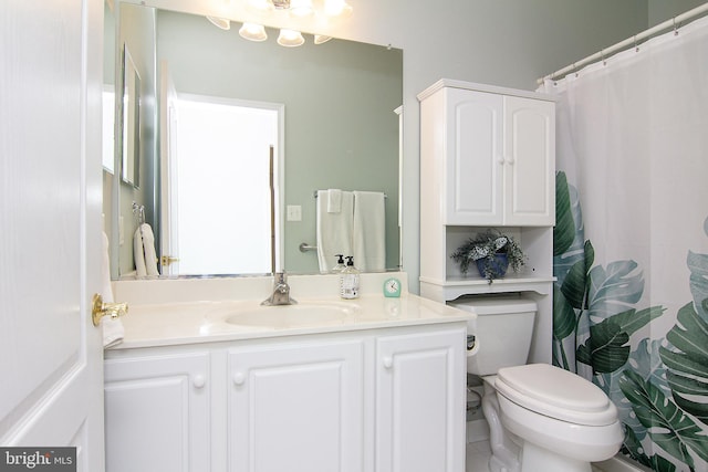 bathroom featuring vanity, toilet, and tile patterned flooring