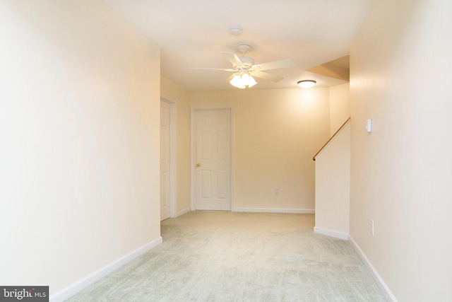 carpeted spare room with ceiling fan