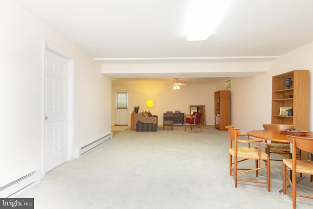 dining area featuring carpet flooring, a baseboard radiator, and ceiling fan