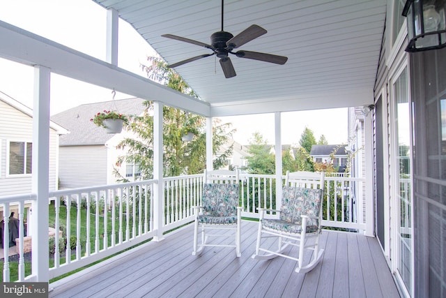 unfurnished sunroom with ceiling fan and vaulted ceiling