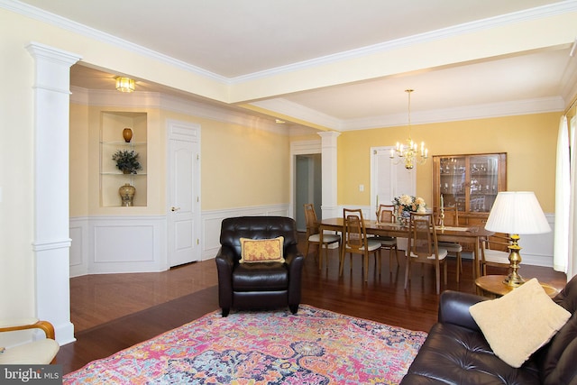 living room with ornamental molding, dark wood-type flooring, ornate columns, and a chandelier