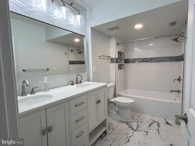 full bathroom with vanity, toilet, and tiled shower / bath combo