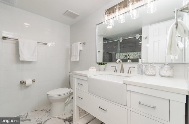 bathroom with an enclosed shower, vanity, and toilet