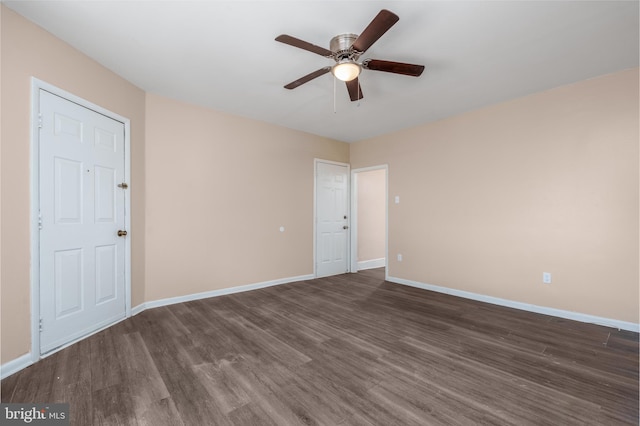 spare room with dark hardwood / wood-style floors and ceiling fan