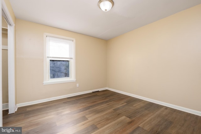 unfurnished room featuring dark hardwood / wood-style flooring