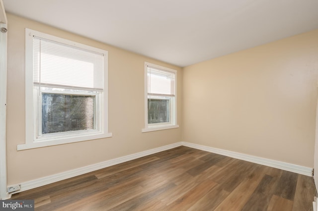 spare room with dark wood-type flooring