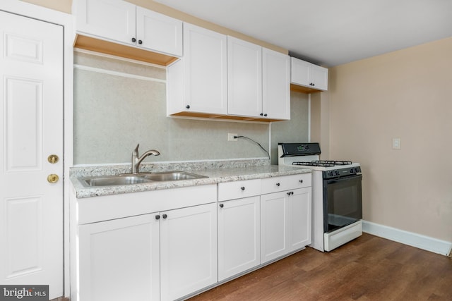 kitchen featuring sink, white cabinetry, white gas range oven, and dark hardwood / wood-style flooring