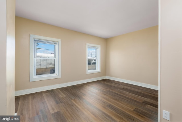 unfurnished room with dark hardwood / wood-style floors