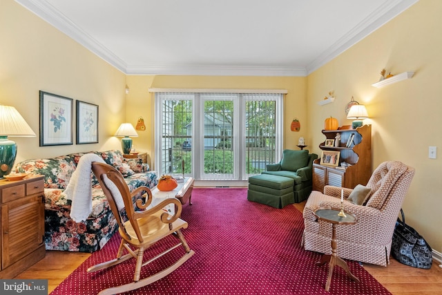 sitting room featuring crown molding and wood-type flooring